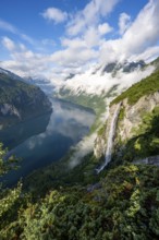 Gjerdefossen waterfall, at Ørnesvingen viewpoint, atmospheric clouds over the fjord in the morning