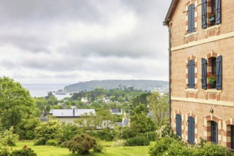 House with a garden and a beautiful sea view on the coast in the summer, Crozon peninsula,