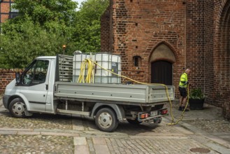 Watering municipal plants from a truck in Ystad, Skåne County, Sweden, Scandinavia