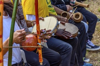 Group of musicians playing berimbau and tambourine in a capoeira performance in Brazil, Minas