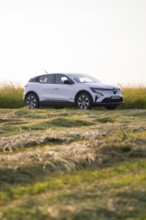 Parked car in a green field landscape, Renault Megane, Deer E Carsharing, electric car, Calw, Black