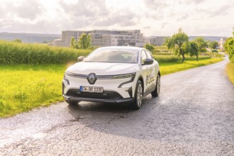 White Renault driving on a country road with the urban background, Renault Megane, Deer E