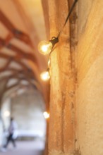 Warm light from fairy lights in a historic stone archway, event and wedding location Lorch