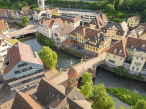 Aerial view of a town with river and many half-timbered houses in sunlight, Calw, Black Forest,