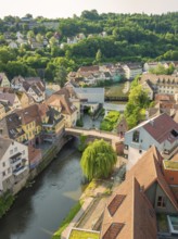 Old town with half-timbered houses along a river, surrounded by green hills, Calw, Black Forest,