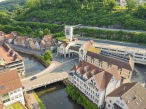 Mixture of modern and historic buildings on a river, surrounded by greenery, Calw, Black Forest,