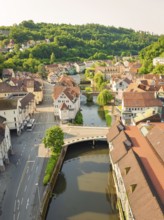 A picturesque town with a river and traditional tiled roofs in summer light, Calw, Black Forest,