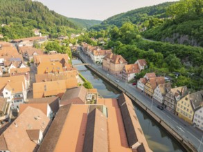 Town with red roofs on a winding river, embedded in forest hills, Calw, Black Forest, Germany