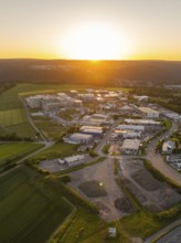 Sunset over an industrial region with surrounding fields and hills, Calw, Black Forest, Germany