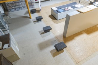 Modern storage room with stairs, shelves and boxes with bright light, historical art exhibition in