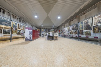 Large exhibition area in an art gallery with paintings on the walls, historical art exhibition in