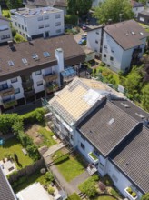 Viewed from above, houses with a partially renovated roof in a green neighbourhood, roof