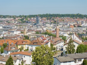 Bird's eye view of a town with various tiled roofs and a church tower, roof renovation, house