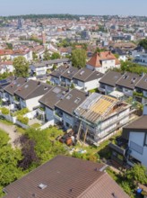 Bird's eye view of a house under renovation in a suburban area with urban view, roof renovation,
