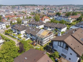 City view with focus on a renovated house roof in a residential area, roof renovation, house