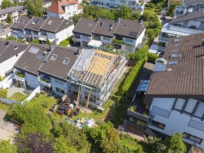 View over a residential area. A roof under renovation, surrounded by other houses, roof renovation,