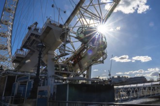 Sunlight streaming through the passenger cabin of the london eye ferris wheel, illuminating the