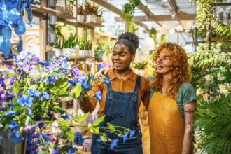 Two young florists arranging vibrant flowers in a charming flower shop, engaging in cheerful