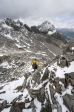 Mountaineer in rocky mountain landscape, at the summit of the Keeskopf, behind summit Kleiner