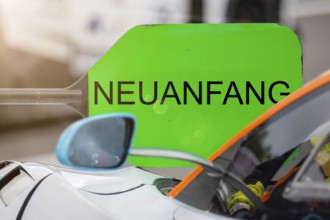 (Photomontage) New beginning Symbol image: Lollipop in motorsport with changed text NEW BEGINNING