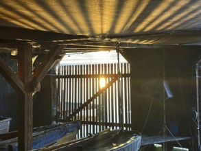 View from a boathouse onto Lake Starnberg at sunset, Bavaria, Germany