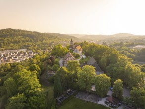 Aerial view of a village with half-timbered houses and church in hilly surroundings, event and