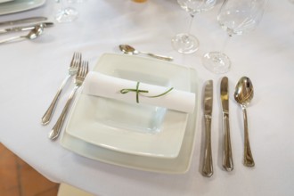 Minimalist table decoration with folded napkin and elegant cutlery, event and wedding location