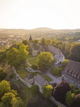 Old church and building on a hill surrounded by trees, event and wedding location Lorch Monastery,