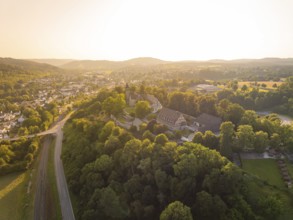 A village on a hill surrounded by forest and half-timbered houses at dusk, event and wedding