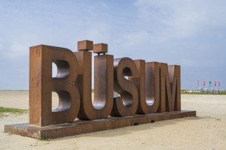 Font with capital letters BÜSUM, sign on the beach, Büsum, North Sea, Schleswig-Holstein, Germany