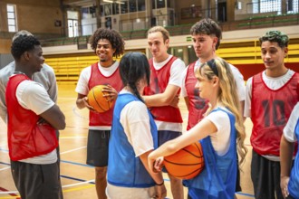 Diverse basketball team engaging in strategic discussions during training sessions in a well lit