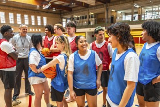 High school basketball team listening to their coach's instructions during a training session in
