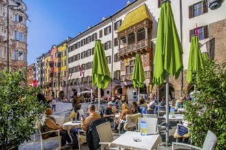 Street café on Herzog-Friedrich-Strasse in the historic city centre with the Golden Roof,