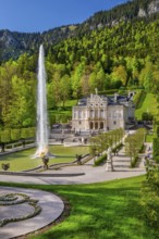 Water parterre with large fountain and portal of Linderhof Castle in spring, municipality of Ettal,