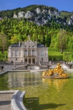Water parterre with flora fountain and the portal of Linderhof Castle in spring, municipality of