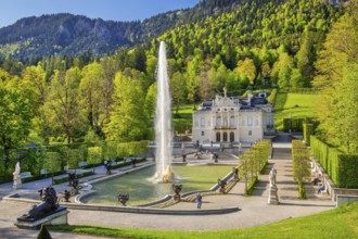Water parterre with large fountain and portal of Linderhof Castle in spring, municipality of Ettal,