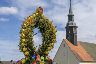 Detail, Easter fountain with church tower, detail in a village in Upper Franconia, Bavaria, Germany