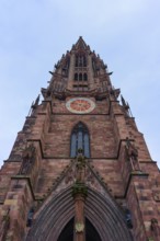 Freiburg Minster, Gothic church tower made of red stone with sculptures and a clock, Freiburg im