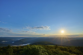 Sunrise with clear sky and wide view over wooded hills, Katzenbuckel, Waldbrunn,