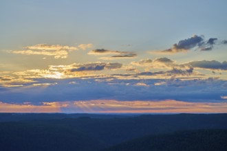 Morning sky with coloured clouds and rays of light over the landscape, Katzenbuckel, Waldbrunn,