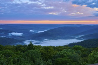 Hilly landscape at dusk, fog in the valleys, orange-blue sky, Katzenbuckel, Waldbrunn,