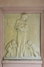 Relief in the inner courtyard of the town hall with inscription Give us today our daily bread,