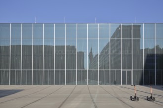 Bauhaus Museum, modern glass building, glass windows, two parked e-scooters, parking, Dessau,