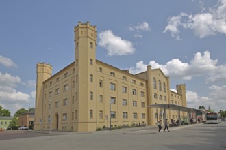 Karlskaserne barracks with corner towers and battlements built in 1919 and today's city