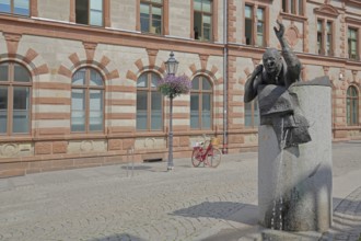 Historic post office and post office fountain with sculpture symbolising silent mail, telephone,