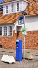 Blue parking ticket machine in the town harbour of Sassnitz, Rügen, Mecklenburg-Vorpommern, Germany