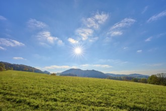 Sunny hilly landscape with a wide view of blue sky and greenery, Vöckelsbach, Mörlenbach,