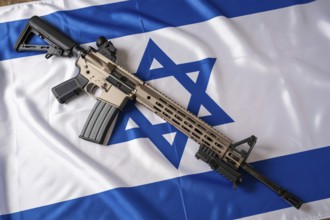 Modern military rifle placed on Israeli flag. Symbol of nationalism, power, and conflict.