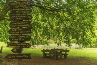 Frau Holle pond in the GEO nature park Park Frau Holle Land am Meissner, seating area, signpost for