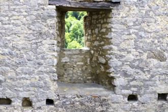 Stone window of the Reußenstein castle ruins with a view of the surrounding nature, Neidlingen